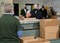 Bidens pack carrots, apples into boxes during food bank stop